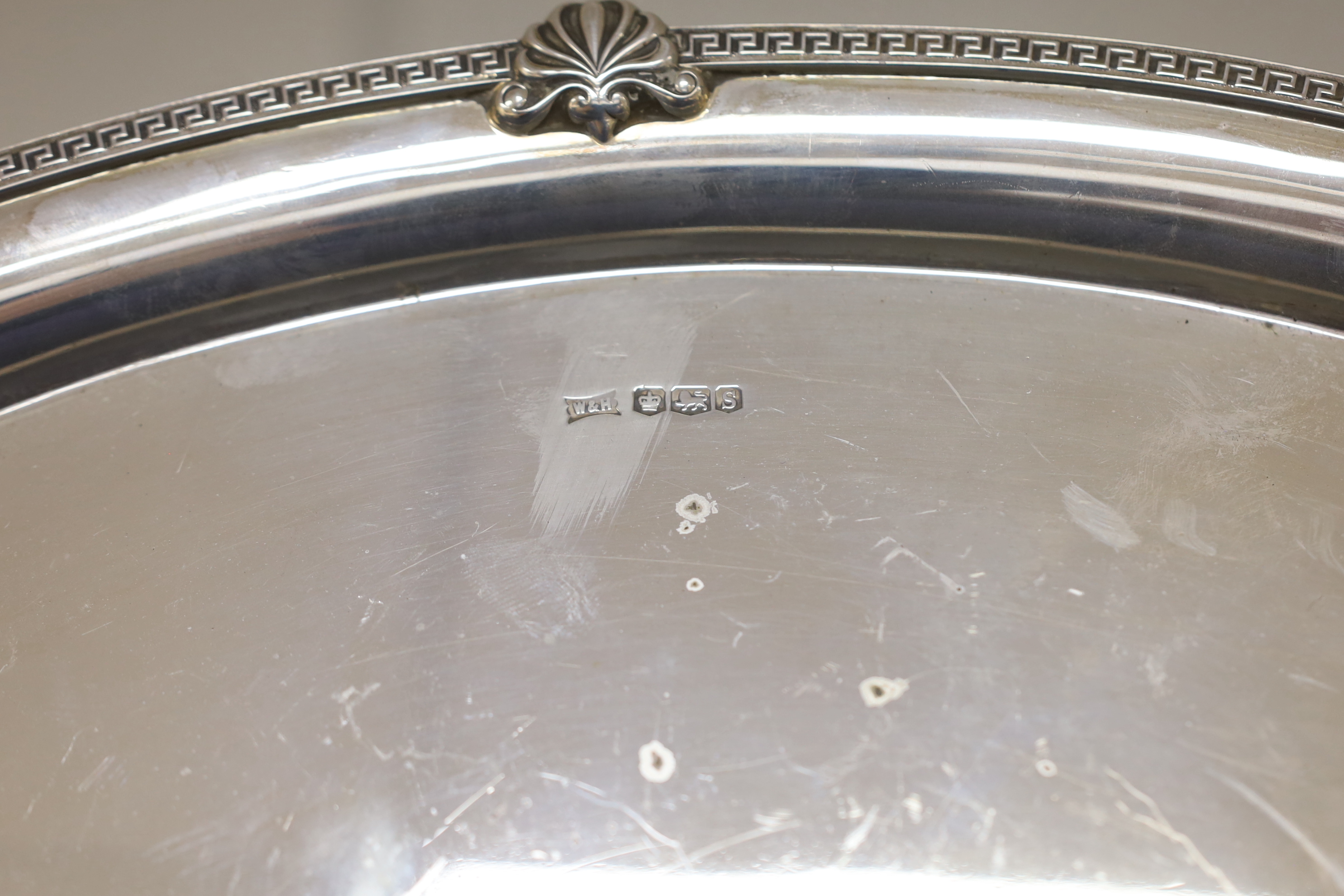 A George V silver oval presentation tea tray, with inset handles, Walker & Hall, Sheffield, 1935, 49.4cm, 54.2oz.